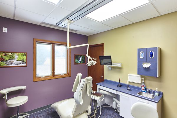 Photo of dentist chair and hallway in dental office